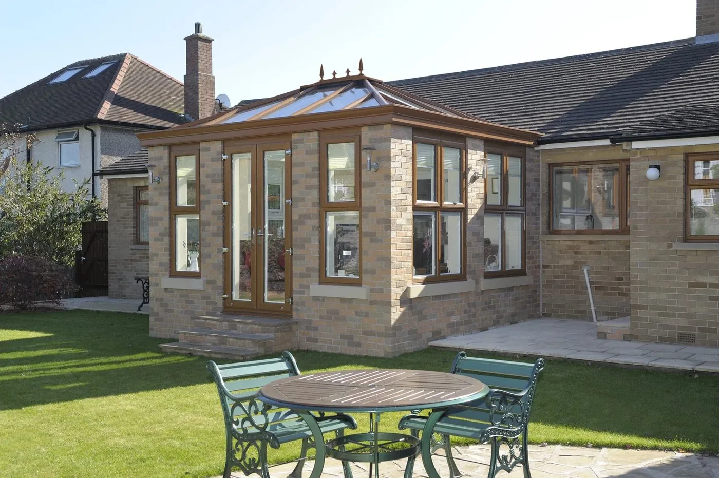Glass-roof orangery in golden oak with a lantern roof